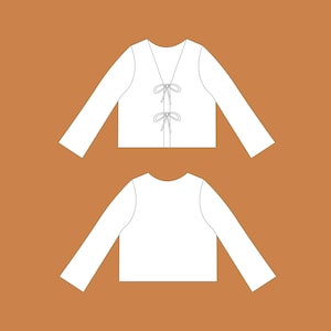 May include: A white long-sleeved shirt with a V-neck and a tie detail at the front.