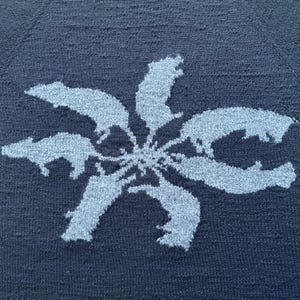 May include: A set of three ceramic mugs with a speckled, matte finish in cream, light grey, and dark grey. Each mug has a simple, minimalist design, suitable for coffee or tea.