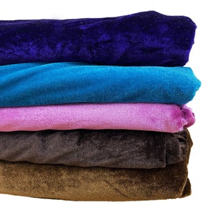 May include: A stack of five fabric swatches in different colors. The top swatch is dark blue, the second is turquoise, the third is pink, the fourth is brown, and the bottom swatch is a lighter brown.