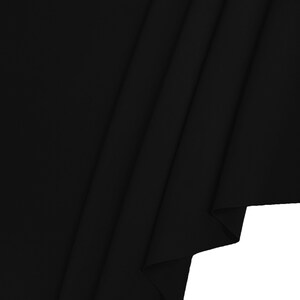 May include: Black fabric with a smooth texture, folded in a diagonal pattern.