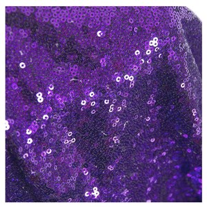 May include: Purple sequin fabric with a close-up view of the sequins.