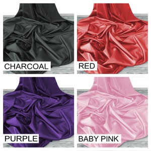 May include: Four fabric swatches in different colors: charcoal, red, purple, and baby pink. The fabric is smooth and silky.