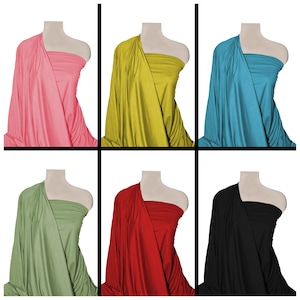 May include: Six fabric swatches draped over mannequins. The swatches are in the following colours: pink, yellow, blue, green, red, and black.