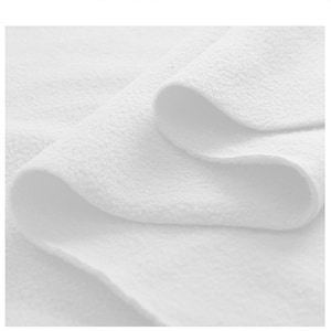 May include: Close-up of a white, soft, and fluffy fabric. The fabric is folded in a way that shows its texture and softness.
