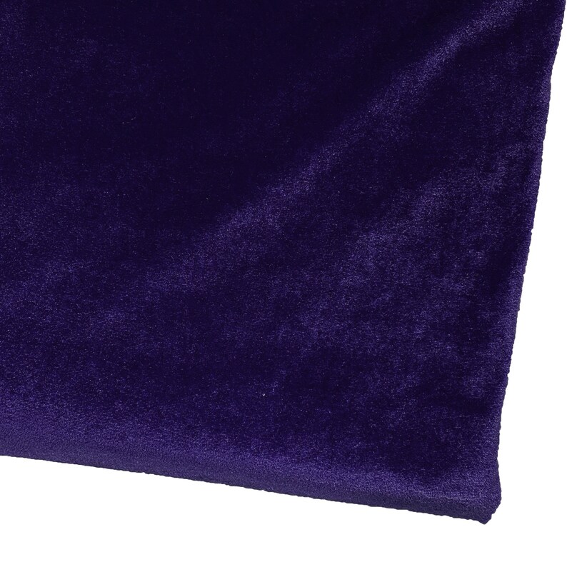 May include: A close-up of a deep purple velvet fabric. The fabric has a soft, plush texture and a rich, luxurious feel.