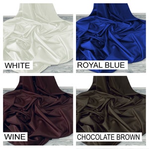 May include: Four fabric swatches in different colors: white, royal blue, wine, and chocolate brown. The fabric is smooth and has a satin finish.
