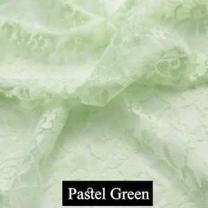 May include: Pale green lace fabric with a floral pattern. The fabric is soft and delicate, and it would be perfect for a variety of projects, such as clothing, accessories, and home decor.