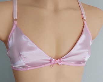 May include: A pink satin triangle bra with adjustable straps and a bow detail in the center.