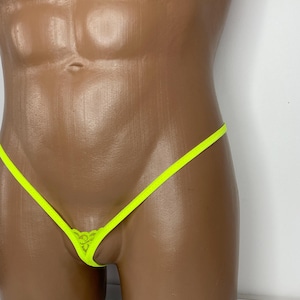 May include: A neon yellow string bikini with a lace detail. The bikini is shown on a mannequin.