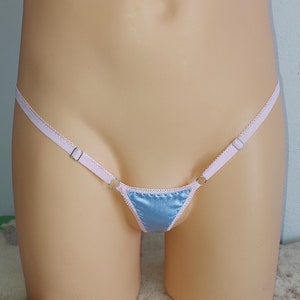 May include: A light blue satin triangle-shaped lingerie with pink satin straps and silver metal rings.