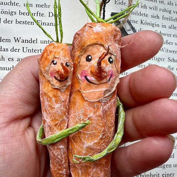 Two carrots mom and child made of paper as upcycling recycling decoration for Easter in the family baby set