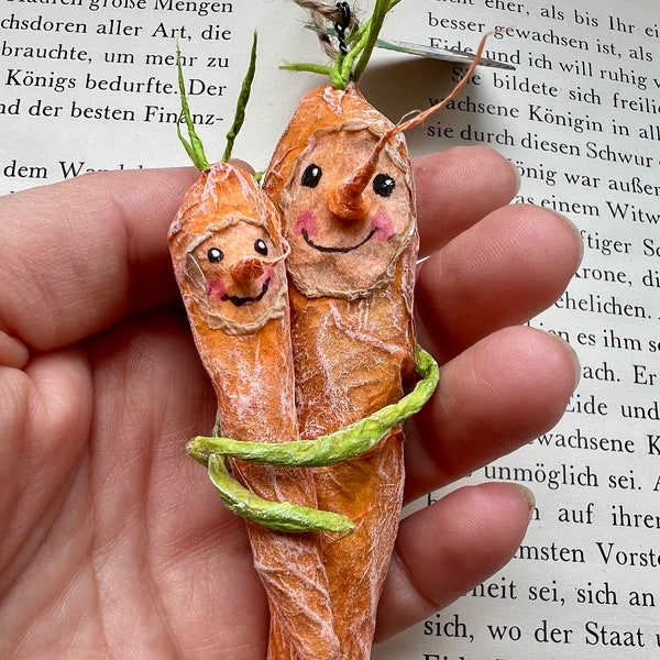 Two carrots mom and child made of paper as upcycling recycling decoration for Easter in the family baby set
