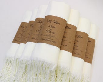 May include: Set of six white pashmina scarves with brown paper tags that say "Stay Warm Laura & Meises 11/16/2014 Thanks for being with us".