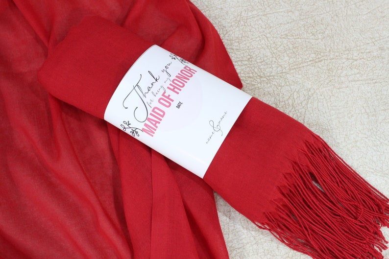 May include: Red pashmina scarf with a white tag that says "Thank you for being my Maid of Honor".