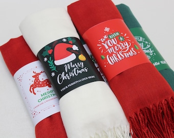 May include: Three different Christmas themed scarves with festive designs and text. The scarves are white, red, and green. The text on the scarves includes "We wish you a merry Christmas", "Merry Christmas", and "Merry Christmas I wish you a wonderful".