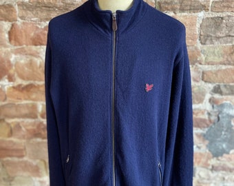 May include: A navy blue zip-up sweater with a small red embroidered logo on the left chest.