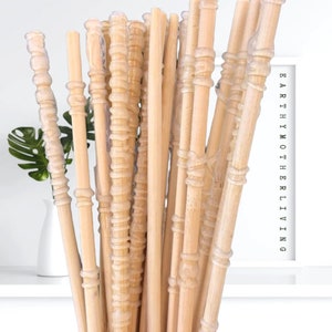 May include: A bundle of natural, light brown, wooden diffuser sticks with a clear, textured coating. The sticks are bundled together and appear to be ready for use in a diffuser.