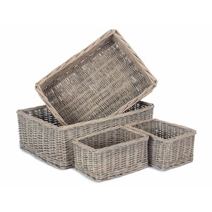 May include: A collection of five rectangular wicker baskets in different sizes. The baskets are a neutral grey colour and have a textured appearance. The largest basket is open and angled, revealing the interior.