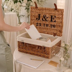 Open personalised wedding card box made from natural wicker with cream lining, leather straps, custom couple initials and wedding date for cards and keepsakes.