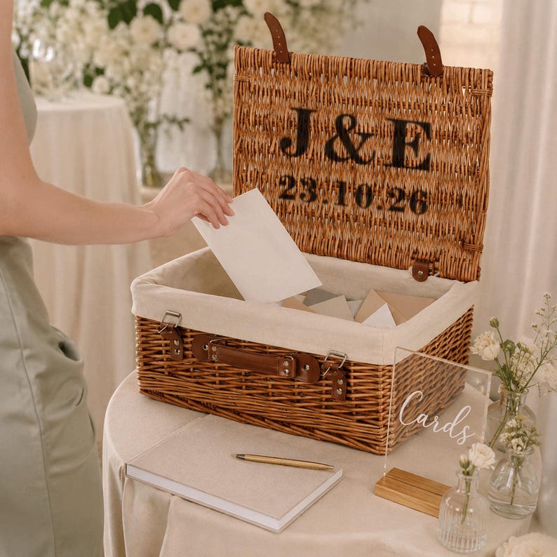 Open personalised wedding card box made from natural wicker with cream lining, leather straps, custom couple initials and wedding date for cards and keepsakes.