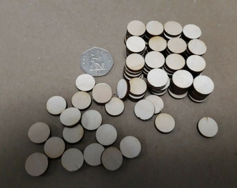 May include: A pile of 50 natural wood round circles, approximately 1 inch in diameter, with a single coin for scale.