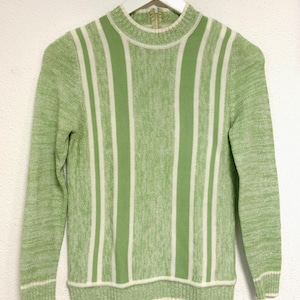 May include: A green and white striped sweater with a mock neck and long sleeves.