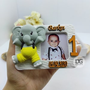 May include: White photo frame with a gray elephant figurine, a photo of a baby boy, and the text "Barkın 05.09.2020" and "DG DOGA GIFTS".