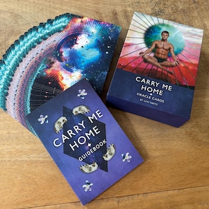 May include: A deck of oracle cards called "Carry Me Home" by Levi Smith, with a guidebook and a card showing a person meditating in a colorful mandala.