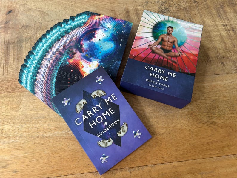 May include: A deck of oracle cards called "Carry Me Home" by Levi Smith, with a guidebook and a card showing a person meditating in a colorful mandala.