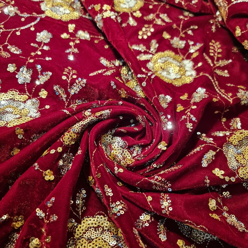 May include: Red velvet fabric with gold and silver sequins embroidered in a floral pattern.
