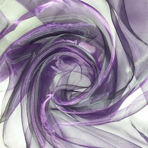 May include: Purple sheer fabric with a shimmery finish, draped and folded to create a swirling pattern.