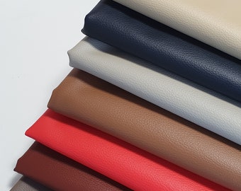 May include: A stack of eight different colored leather fabric swatches. The swatches are arranged in a graduated color scheme from light beige to dark brown.