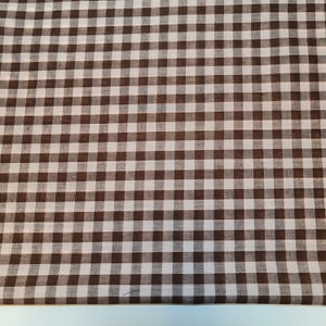 May include: Brown and white gingham fabric with a checkered pattern.