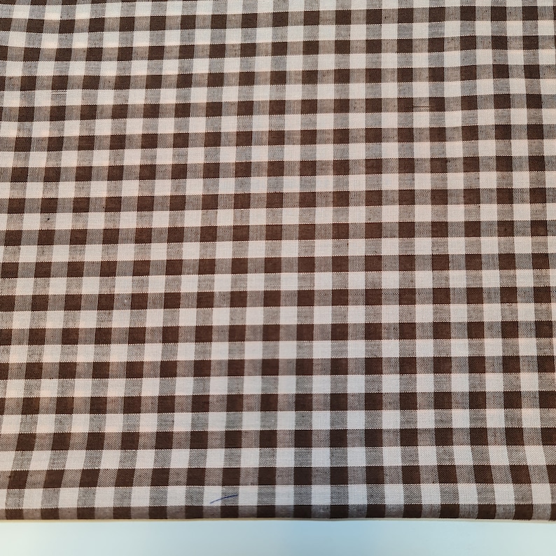 May include: Brown and white gingham fabric with a checkered pattern.