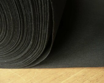 May include: A roll of black fabric with a textured surface.