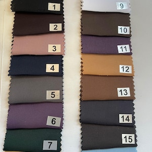May include: A color swatch card featuring sixteen fabric samples in various colors. The samples are arranged in vertical rows and include shades of black, brown, pink, navy, gray, purple, green, tan, white, and blue. Each swatch is labeled with a number.