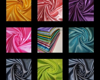 Puede incluir: Una colección de nueve muestras de tela en varios colores, incluyendo amarillo, rosa, morado, verde azulado, verde y gris. La tela es un material suave y satinado.