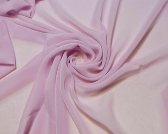May include: A close-up of a soft, light purple fabric with a flowing, draped texture.