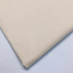 May include: A close-up of a piece of natural beige fabric with a slightly textured surface.