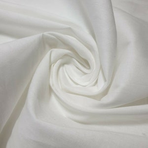 May include: White fabric with a smooth texture, folded and draped in a soft, flowing pattern.