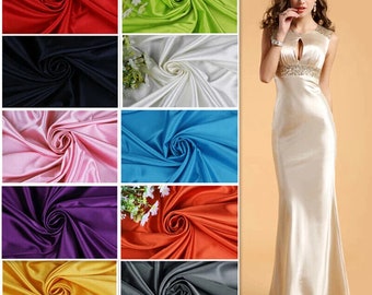 May include: A collection of 10 fabric swatches in various colors, including red, green, white, blue, pink, purple, orange, yellow, gray, and black. Each swatch is folded in a spiral shape.