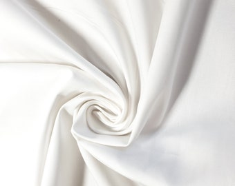 May include: White fabric with a smooth, silky texture, folded and twisted into a spiral shape. The fabric is soft and flowing, creating a sense of elegance and luxury.