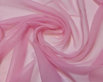 May include: A soft, pink sheer fabric with a delicate texture. The fabric is draped and folded, creating a flowing and elegant look.