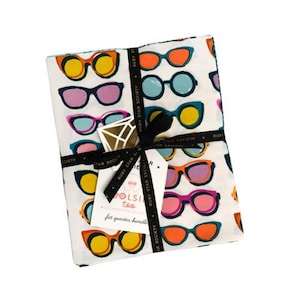 May include: A bundle of white fabric printed with a pattern of sunglasses in various colours, including orange, yellow, pink, blue, and teal. The bundle is tied with a black ribbon and a tag that reads "OLSI too".