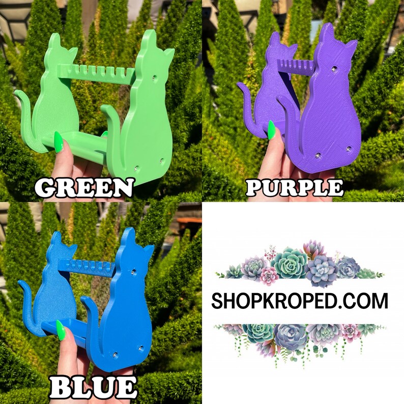 May include: Three cat-shaped, 3D printed, wall-mounted organizers in green, purple, and blue. Each organizer has two shelves and a cat silhouette design. The text "SHOPKROPED.COM" is visible in the background.