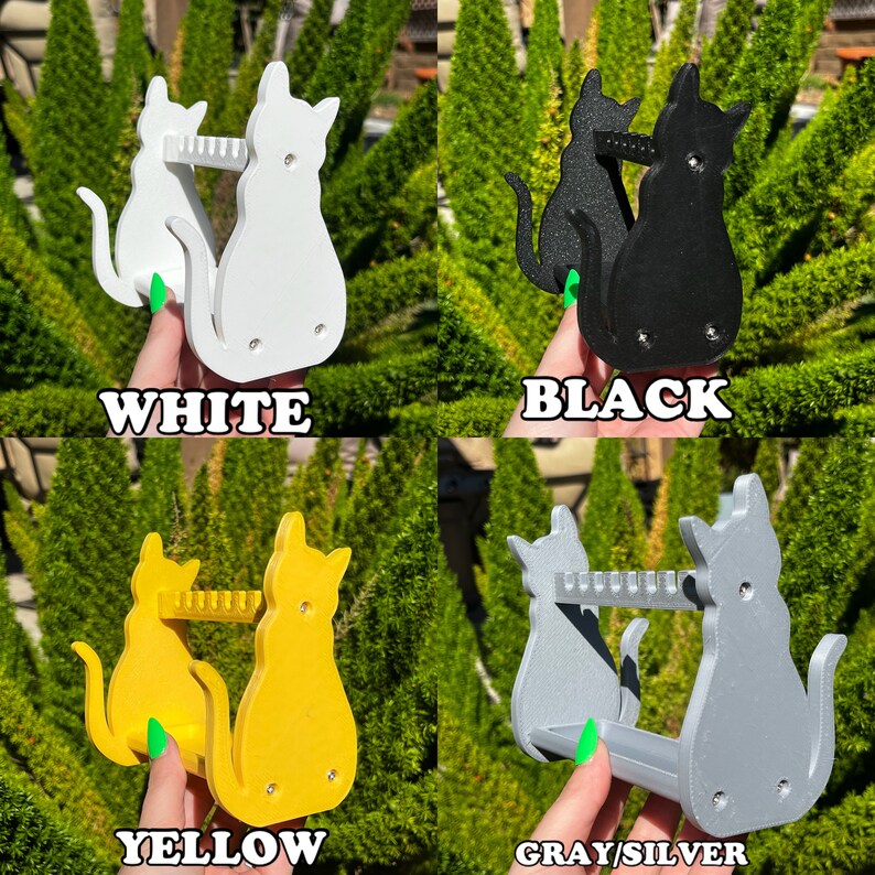 May include: Four cat-shaped wall-mounted earring holders in white, black, yellow, and gray. Each holder features two cats with a row of hooks between them.