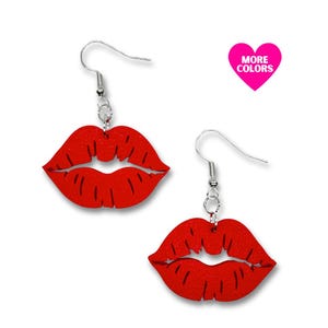 May include: Red lips dangle earrings with silver hooks. The earrings are made of wood and have a textured finish. More colours are available.