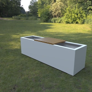 May include: A rectangular, white planter box with a built-in wooden bench. The planter is set on a grassy lawn, with trees and foliage in the background. The bench is made of wooden slats.
