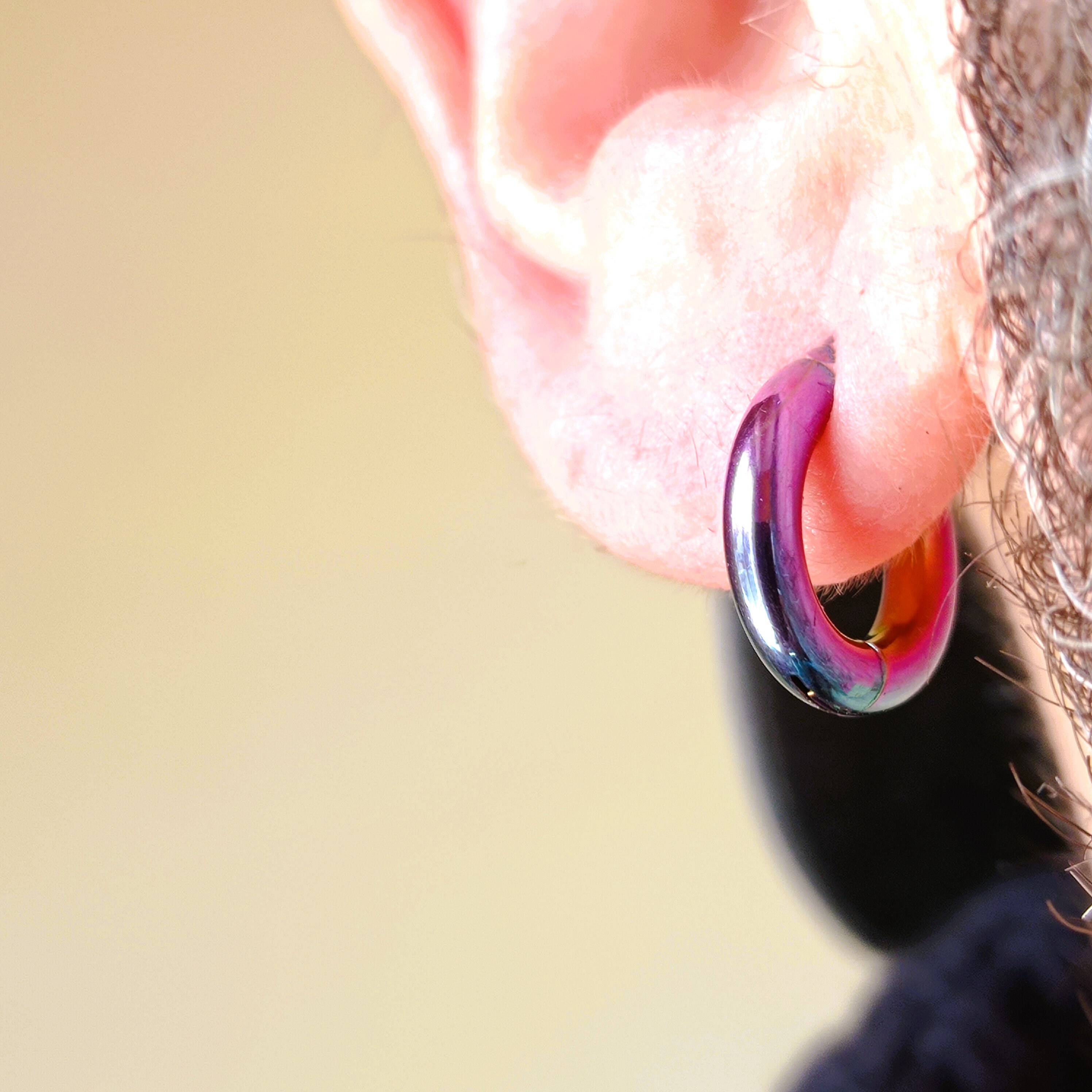 14 mm outer iridescent gold stainless steel hoop · clip-on closure.