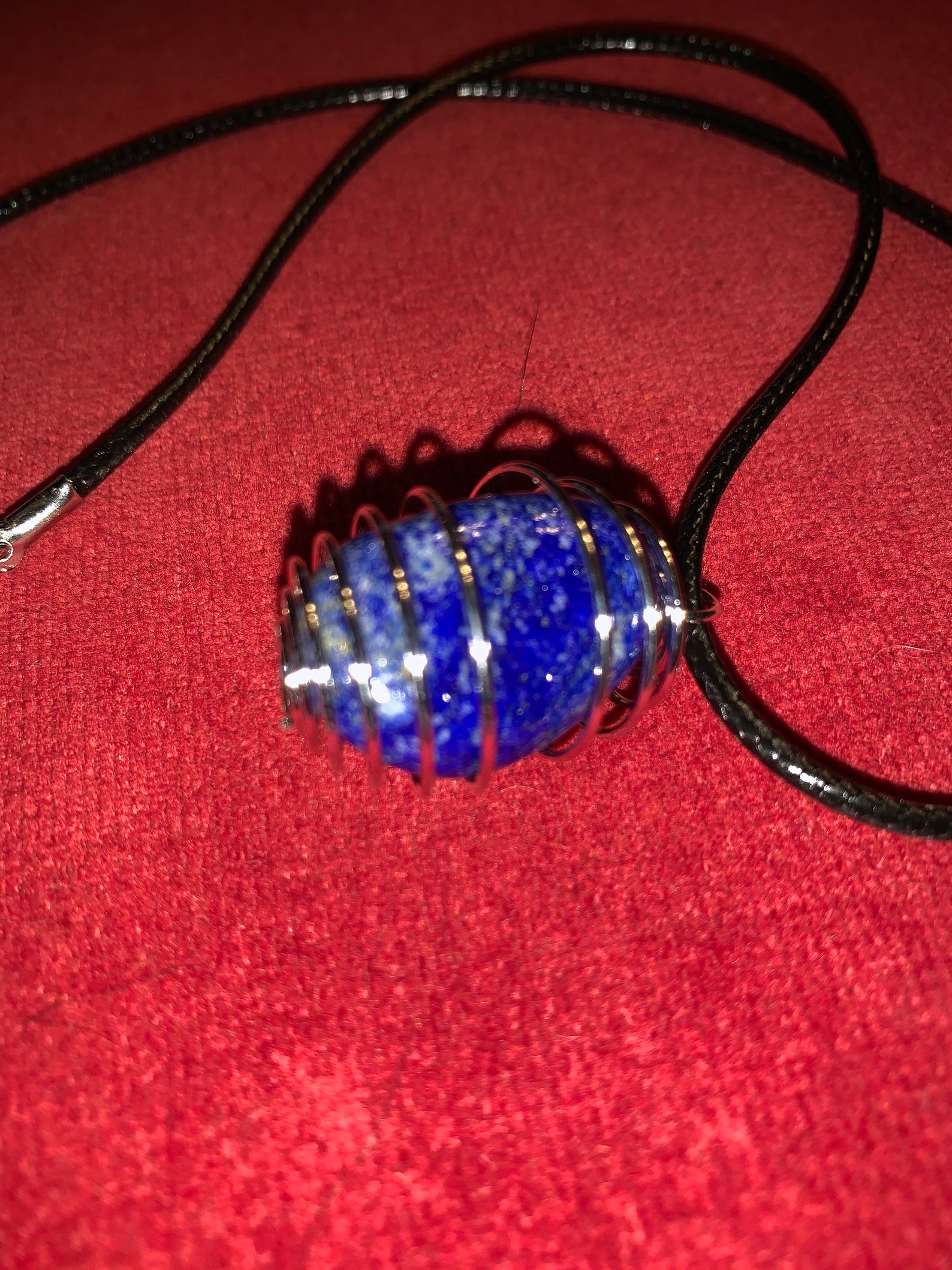 Polished blue stone pendant on black corded necklace. Etsy